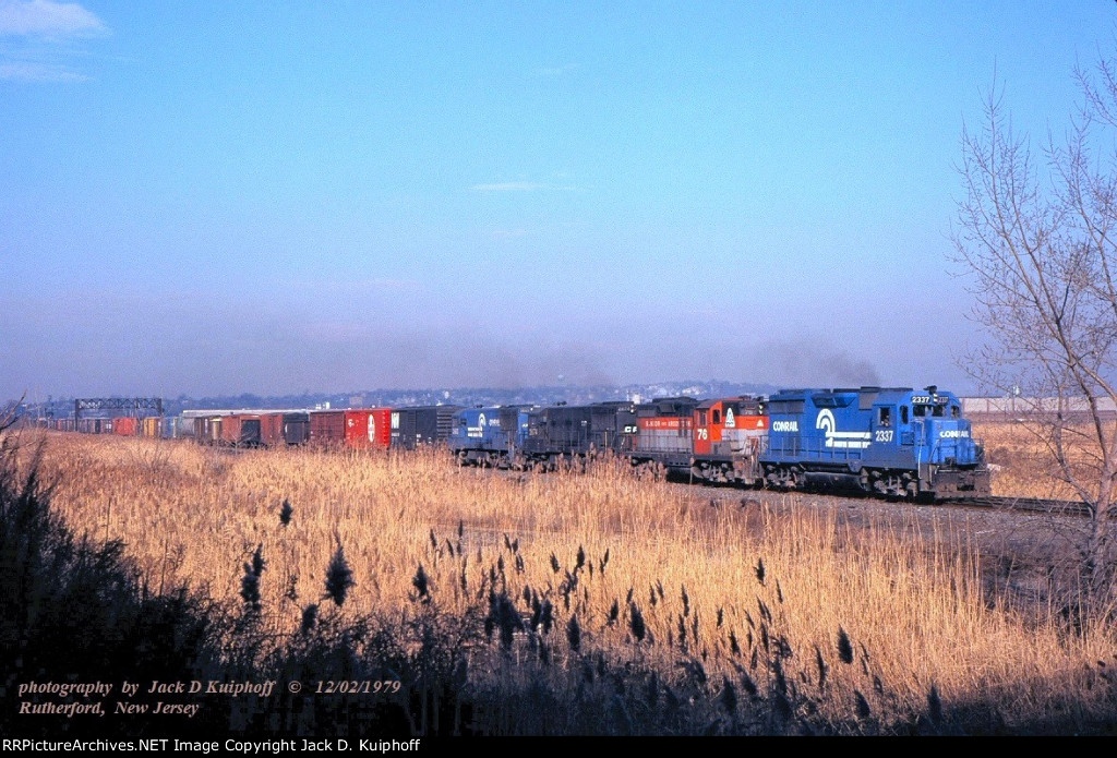 CR, Conrail GP35 2336 -BAR GP9 76 -CR U25B 2676- 2682, with eastbound IHCR-3, on the ex-ERIE mainline across the meadowlands at East Rutherford, New Jersey. December 2, 1979.  